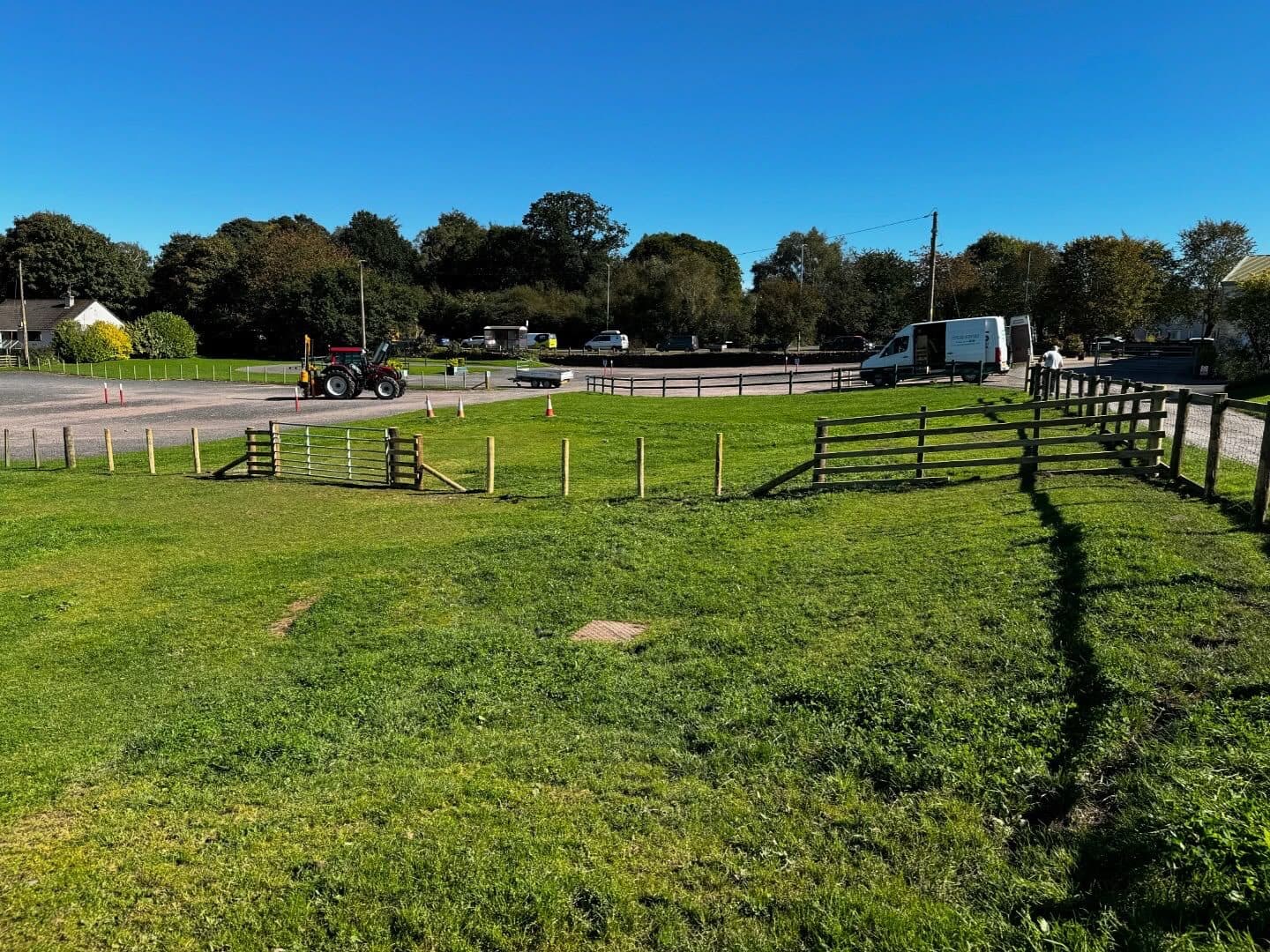 Post-and-rail fencing running alongside a country road