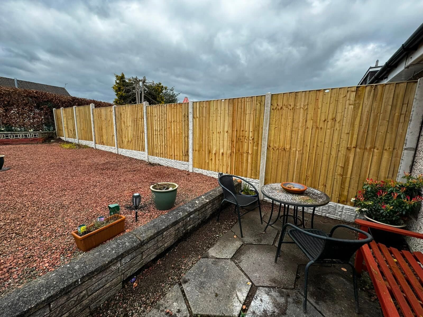Close-board timber fence enclosing a garden patio area