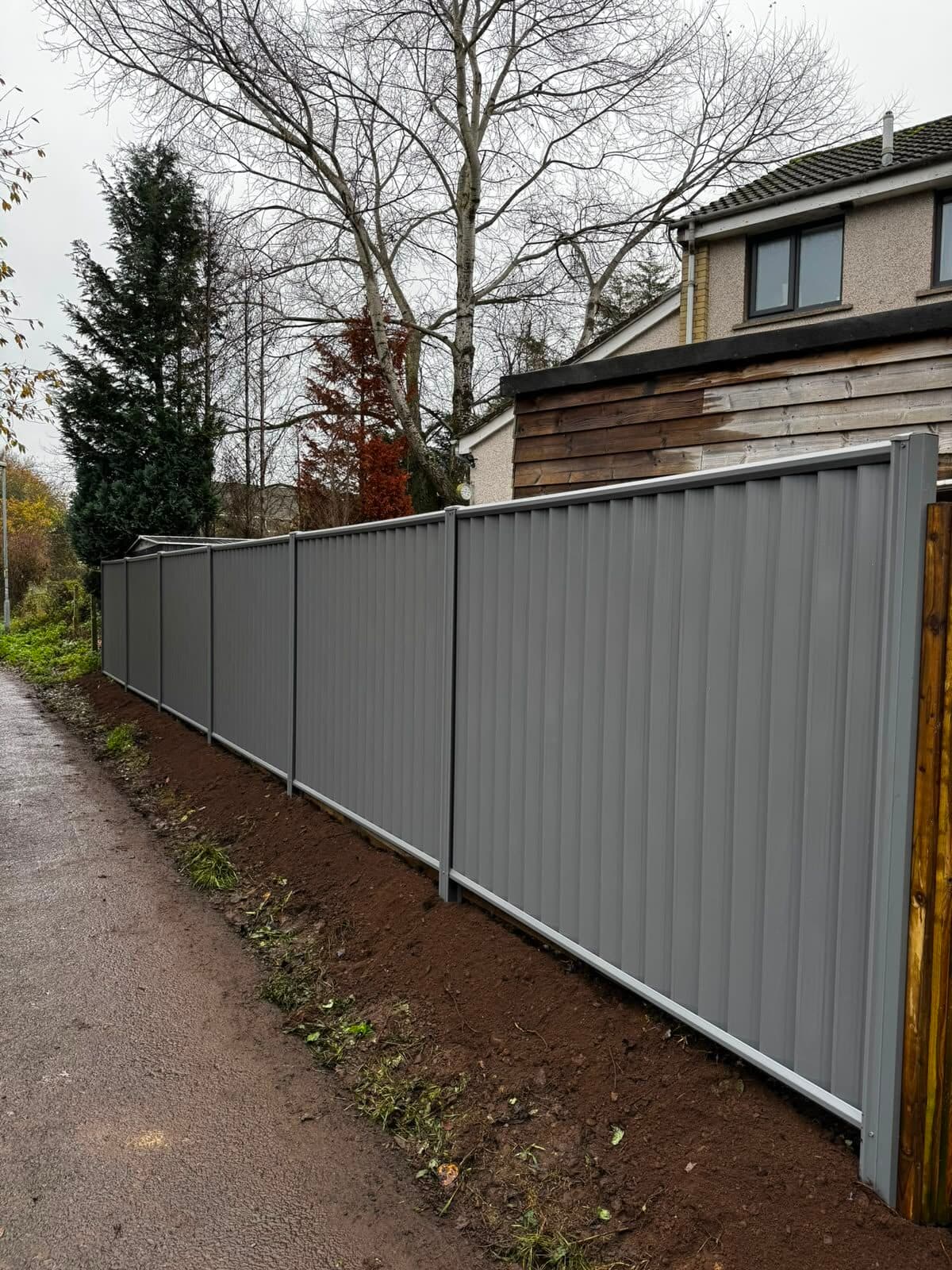 Steel security fencing along a garden boundary next to a footpath