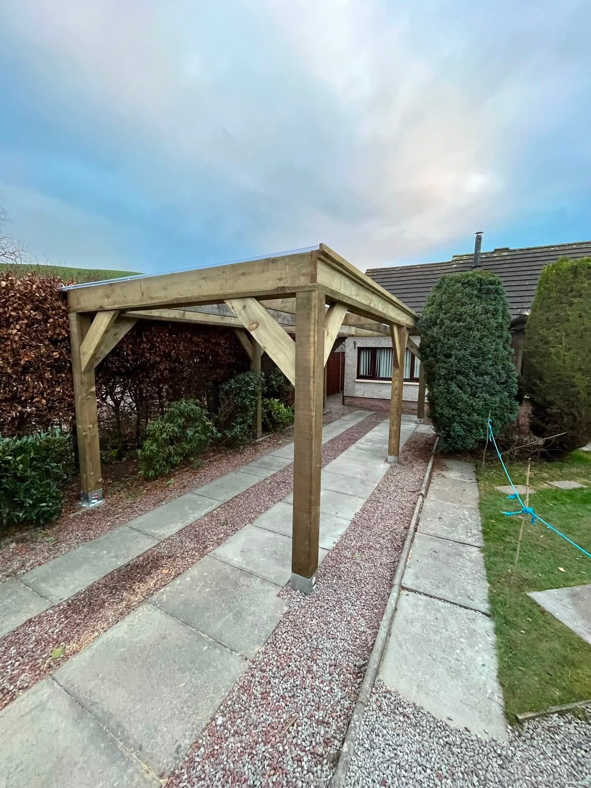 Timber canopy shelter built over a garden path