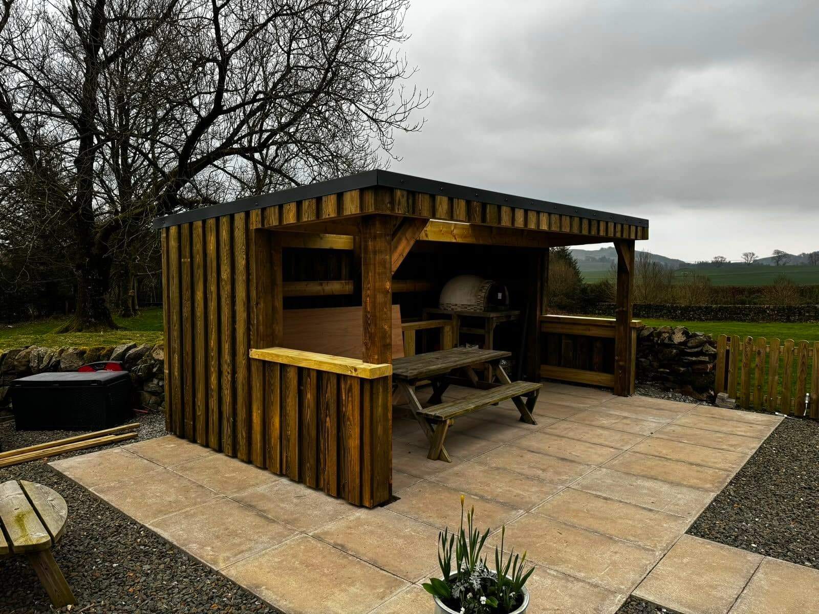 Timber BBQ shelter built beside a patio